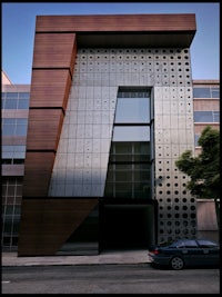 a modern building with a car parked in front of it